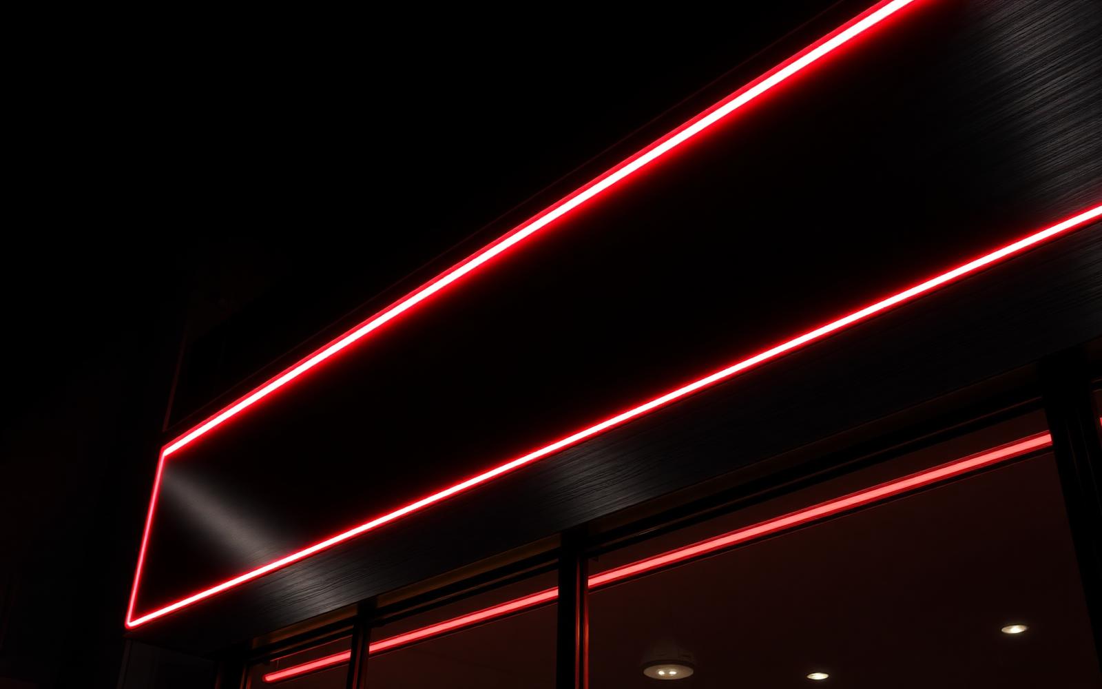 Illuminated red and black storefront signage at night